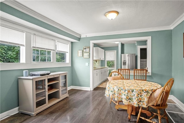 dining space with dark hardwood / wood-style flooring and crown molding