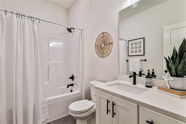 full bathroom featuring vanity, shower / bath combo, tile patterned flooring, and toilet