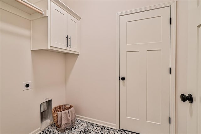 clothes washing area featuring cabinets, light tile patterned flooring, and electric dryer hookup