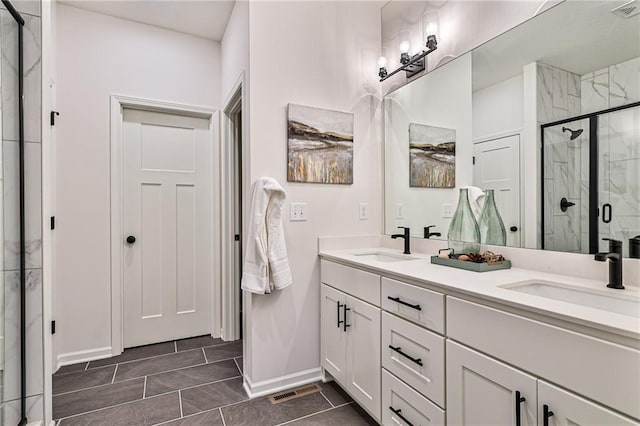 bathroom featuring tile patterned flooring, walk in shower, and double vanity