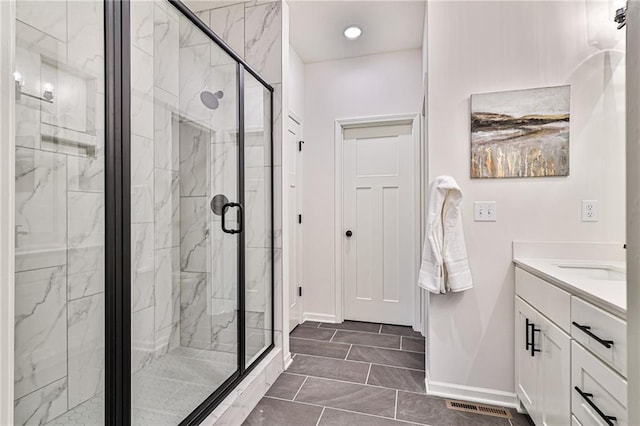 bathroom with tile patterned floors, a shower with shower door, and vanity