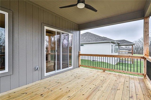 deck with ceiling fan and a lawn