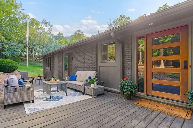 deck with an outdoor living space with a fire pit