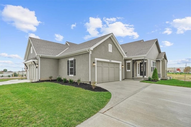 view of front of house featuring a front lawn and a garage