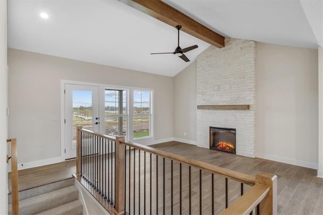 interior space featuring french doors, lofted ceiling with beams, and hardwood / wood-style flooring