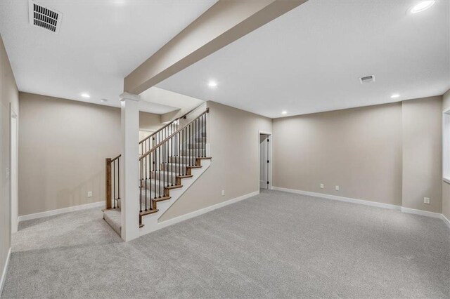 basement featuring light colored carpet