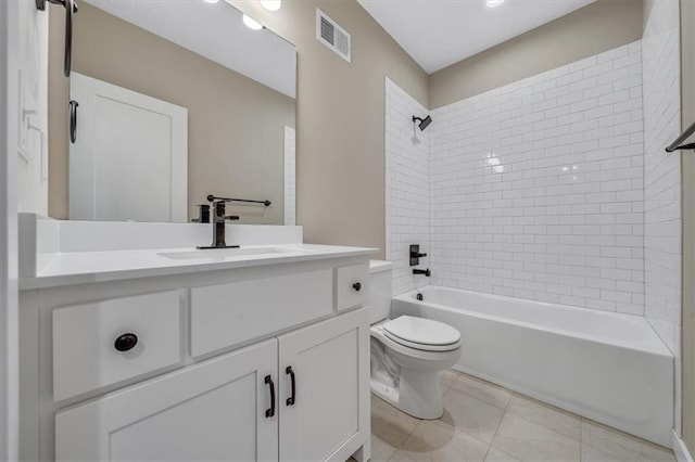 full bathroom with tile patterned floors, vanity, tiled shower / bath combo, and toilet