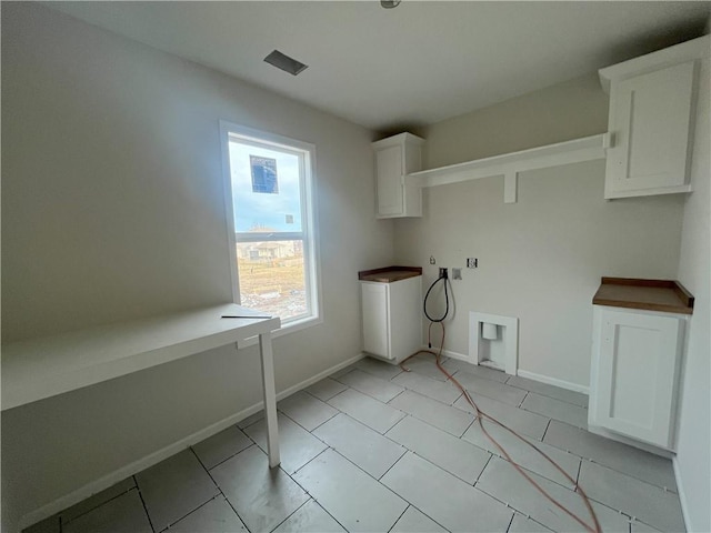 laundry room featuring washer hookup, cabinets, and hookup for an electric dryer