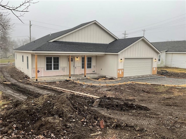 view of front of home featuring a garage and covered porch