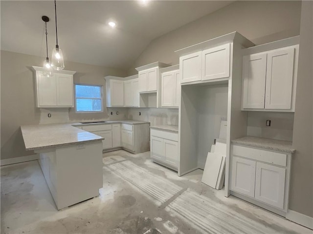 kitchen featuring white cabinets, decorative light fixtures, and light stone counters