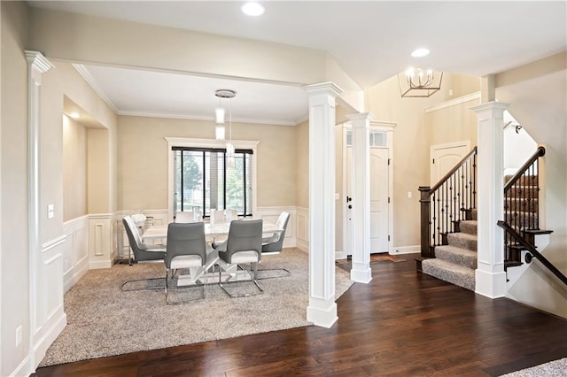 dining space featuring ornamental molding, a chandelier, decorative columns, and dark hardwood / wood-style floors