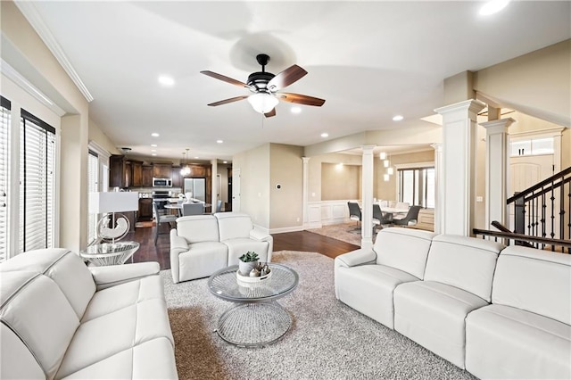 living room featuring ceiling fan, decorative columns, and dark hardwood / wood-style flooring