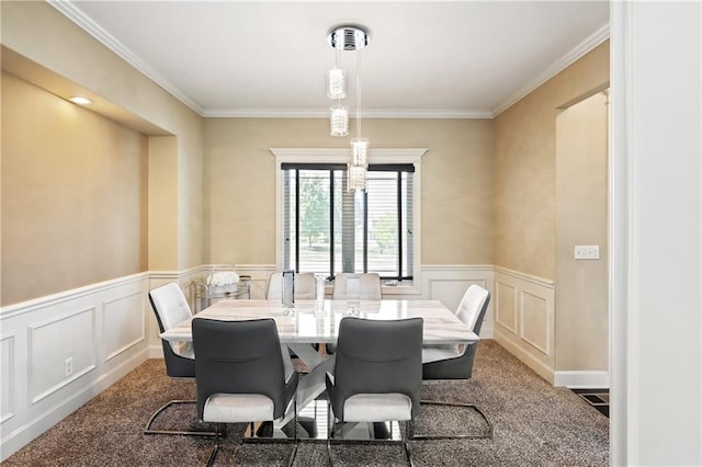 carpeted dining room with ornamental molding