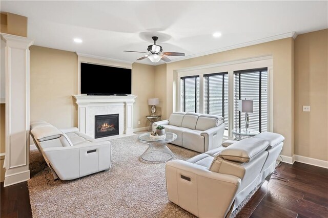 9614 NE 97th St, Kansas City, MO 64157 - living room featuring dark wood-style flooring, baseboards, ornamental molding, a fireplace with flush hearth, and ceiling fan