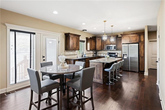 9614 NE 97th St, Kansas City, MO 64157 - dining room featuring baseboards, dark wood-style floors, visible vents, and recessed lighting