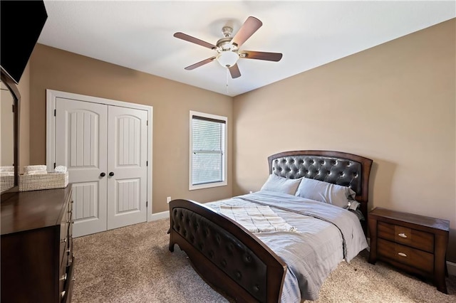 carpeted bedroom featuring ceiling fan and a closet