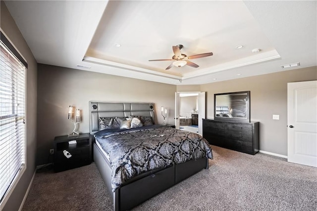 bedroom featuring ceiling fan, carpet floors, and a tray ceiling