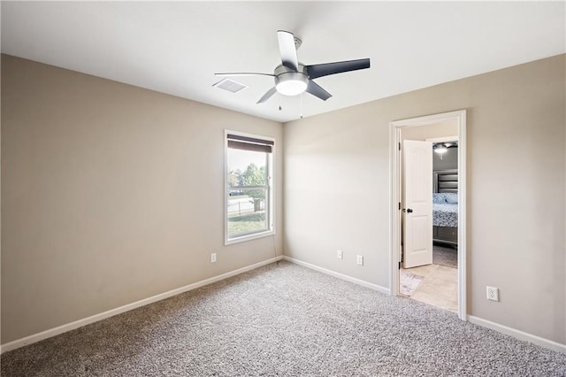 carpeted empty room featuring ceiling fan