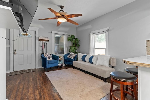 living area with dark wood finished floors and ceiling fan