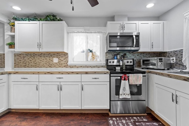 kitchen featuring stainless steel appliances and white cabinetry