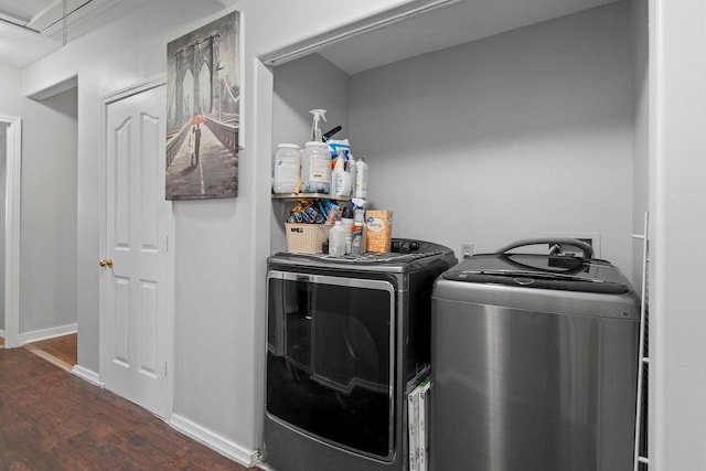 washroom with laundry area, attic access, baseboards, dark wood-style floors, and washer and dryer