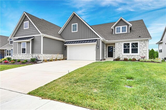 craftsman inspired home featuring a garage and a front lawn