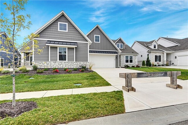 craftsman house with a garage and a front yard