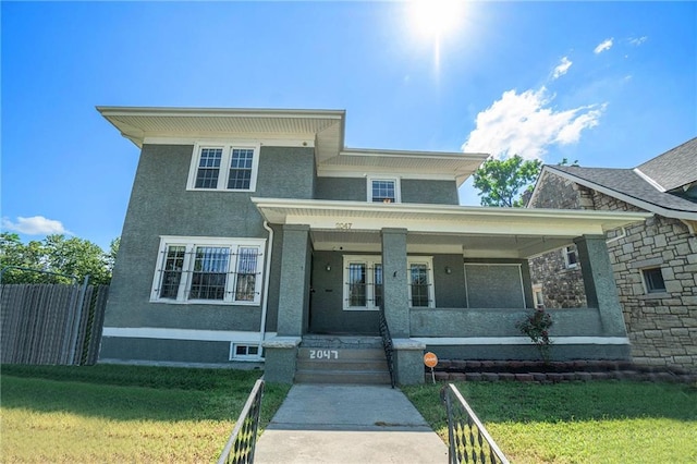 view of front facade with a front yard and covered porch