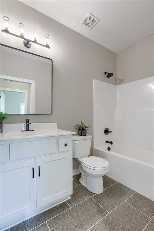 full bathroom featuring vanity, tile patterned flooring, toilet, and shower / bath combination