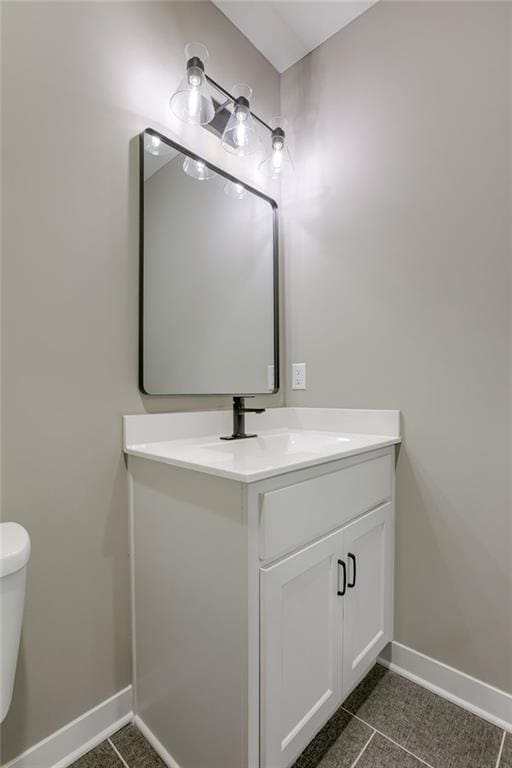 bathroom with vanity, toilet, and tile patterned floors