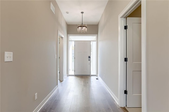 interior space with hardwood / wood-style flooring and an inviting chandelier