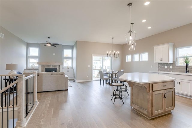 kitchen with white cabinetry, a center island, and a wealth of natural light