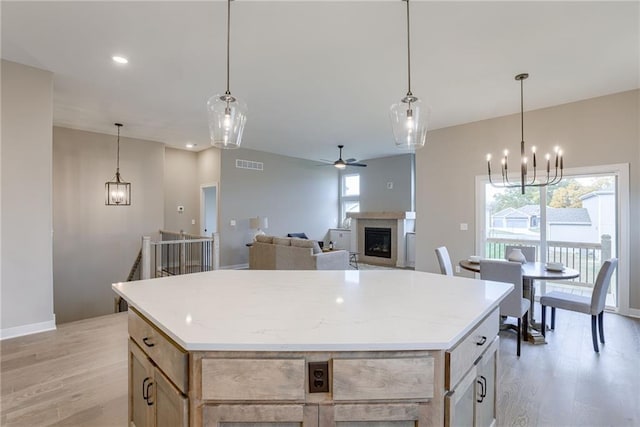 kitchen with light hardwood / wood-style flooring, hanging light fixtures, and a kitchen island