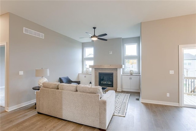 living room featuring light wood-type flooring and ceiling fan