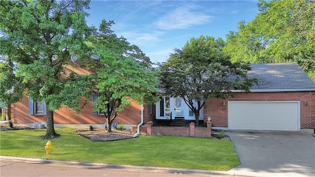 view of front of home featuring a garage and a front lawn