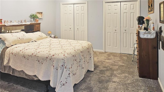 bedroom with multiple closets and carpet floors