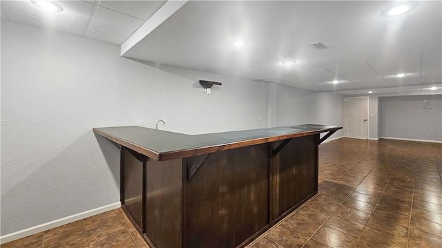 bar with dark tile patterned floors