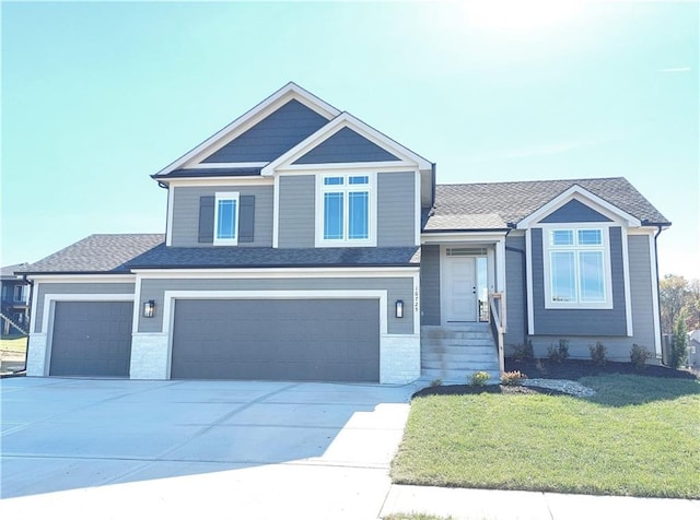 view of front of home with a front lawn and a garage