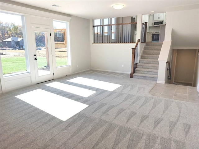 unfurnished living room with light carpet