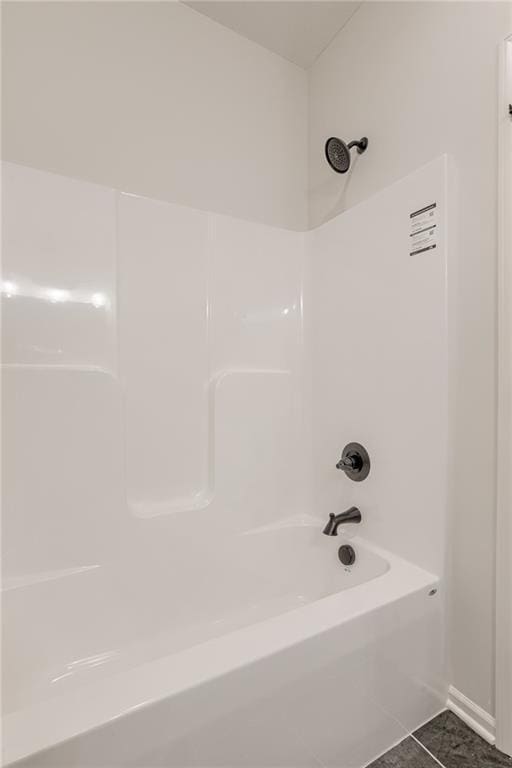 bathroom featuring tile patterned flooring and shower / tub combination