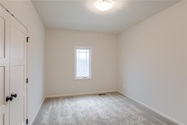 spare room with light carpet