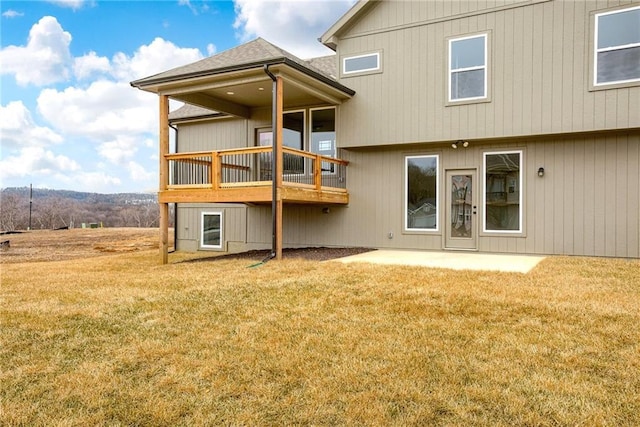 rear view of property featuring a lawn and a patio area