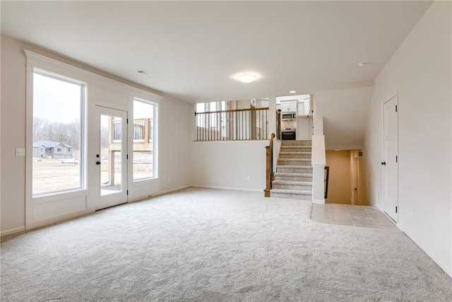 unfurnished living room featuring light colored carpet