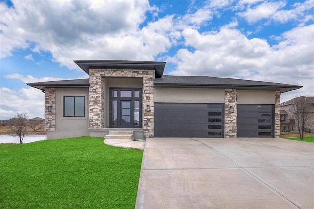 prairie-style home with a garage and a front lawn