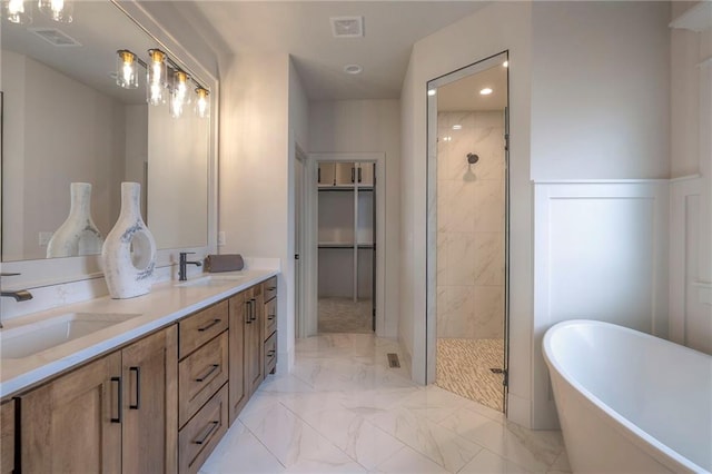 bathroom featuring vanity and independent shower and bath