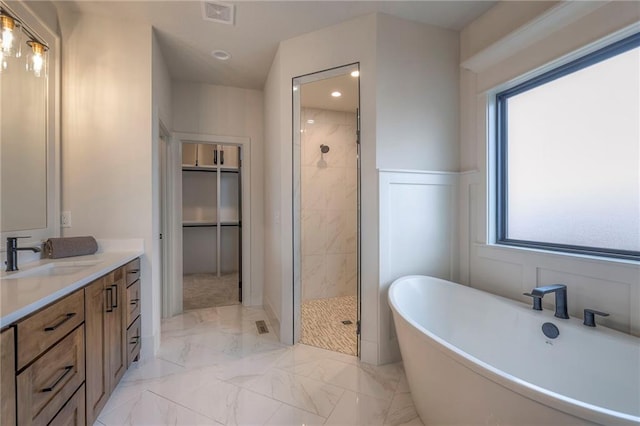 bathroom featuring vanity and shower with separate bathtub