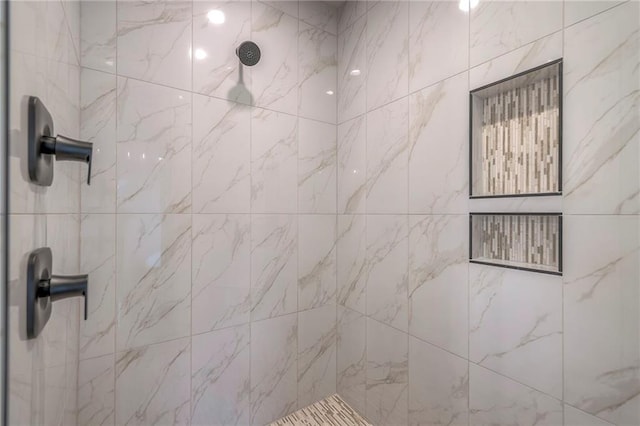 bathroom with a tile shower