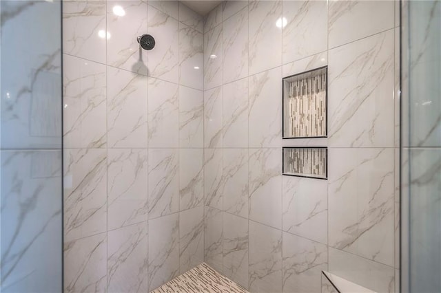 bathroom with tiled shower