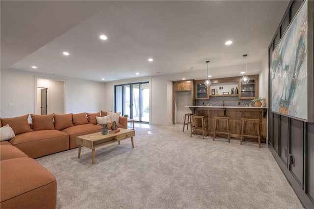 carpeted living room with bar area