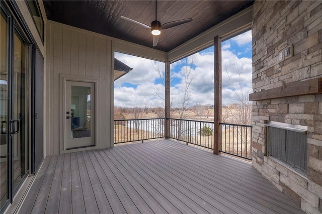 wooden terrace with ceiling fan and a water view